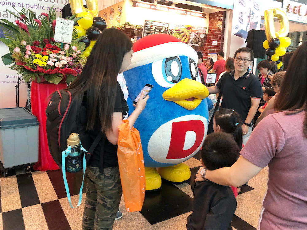 don don donki at changi jewel event marketing with mascot posing for photo with people